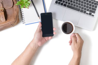 Business man holding smart phone and hot coffee 