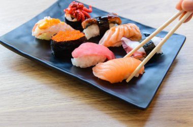 Salmon Sushi with chopstick and Nigiri Sushi set on clay plates