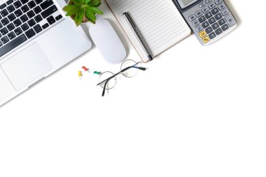 White office desk table with laptop computer and blank notebook. Top view with copy space, flat lay.