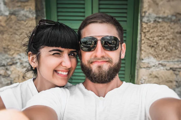 Couple makes a selfie. Man and woman doing a selfie. Man and woman resting at the resort. A couple in love travels. Honeymoon. Honeymoon trip. Photo on the phone