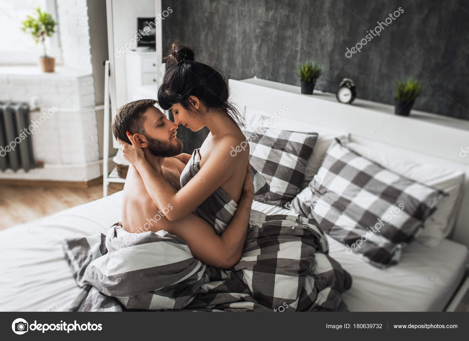 husband and wife making love in bed