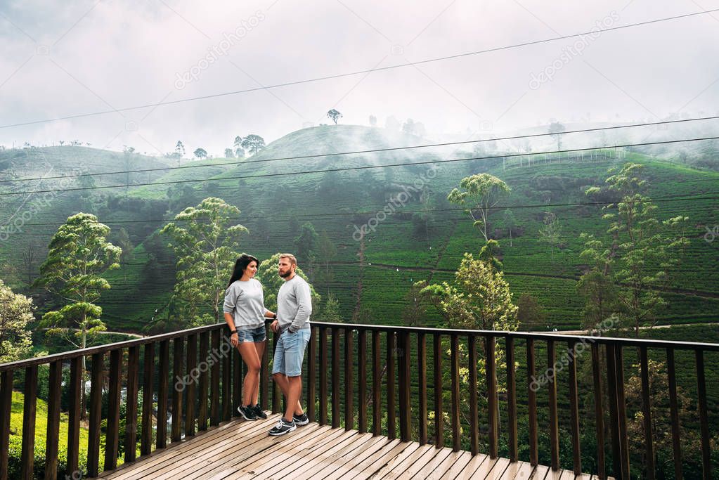Couple in love at tea plantation. Travel to Sri Lanka. Green tea plantations in the mountains. Guy and girl traveling around Asia. Man and woman traveling. Tea plantations in Sri Lanka. Loving couple