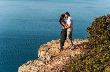 Gün batımında deniz kenarında aşık bir çift. Balayı. Balayı gezisi. Denizdeki kız ve erkek. Erkek ve kadın seyahat ediyor. Birkaç kucaklama. Çift öpüşmesi. Yeni evli bir çift. Sevgililer. Tatil aşkı