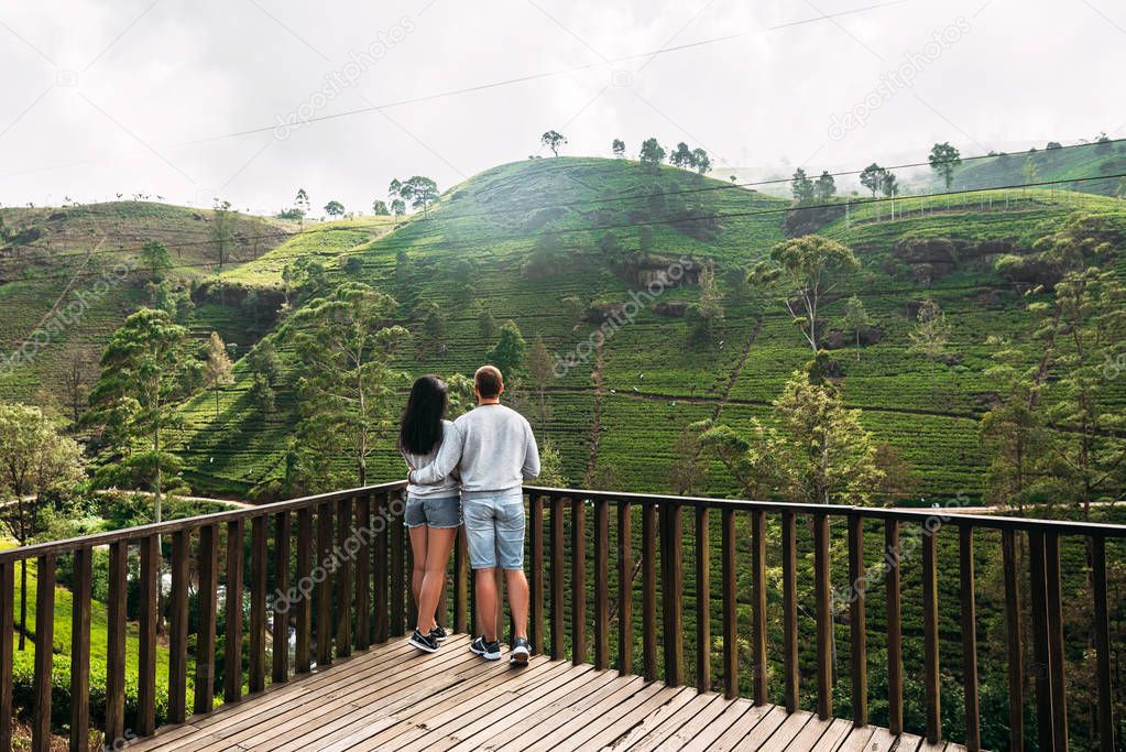 Couple in love at tea plantation. Travel to Sri Lanka. Green tea plantations in the mountains. Guy and girl traveling around Asia. Man and woman traveling. Tea plantations in Sri Lanka. Loving couple