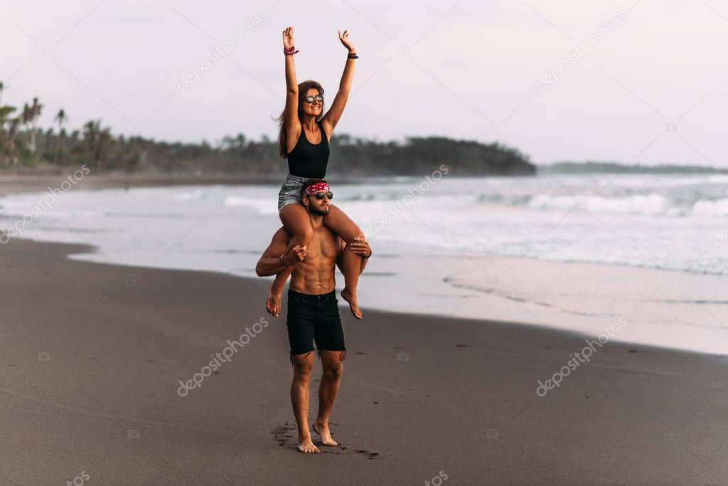 Happy couple on vacation. Lovers on the coast. Man and woman are resting on the sea. Beautiful couple have fun at the sea. Vacation at sea. Vacation on the island of Bali. Travel to Asia