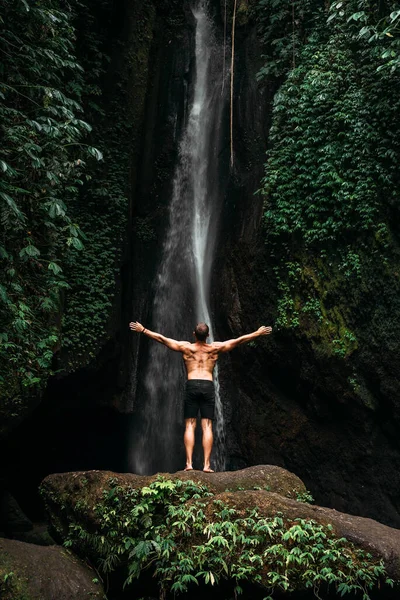 Back View Man Standing Waterfalls Arms Outstretched Man Waterfall Raising — Stock fotografie