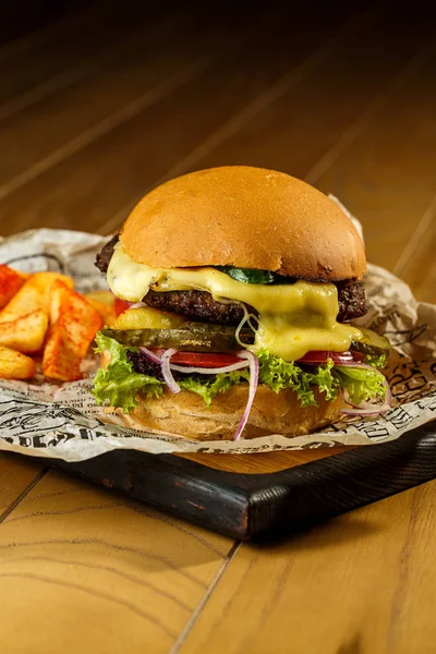 Craft beef burger and french fries on wooden table — Stock Photo, Image