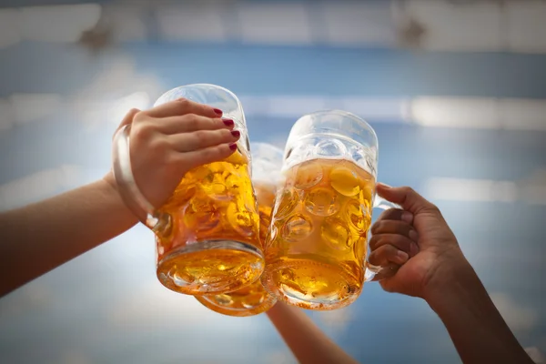 Raised beer mug toasting at Oktoberfest — Stock Photo, Image