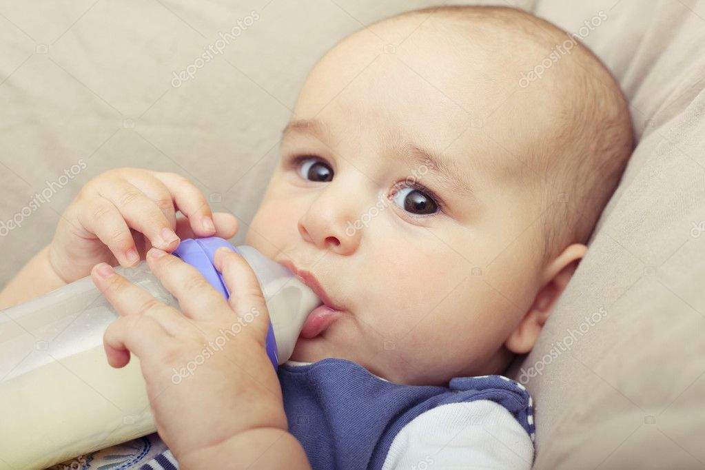 Baby boy drinking breast milk from the bottle — Stock Photo