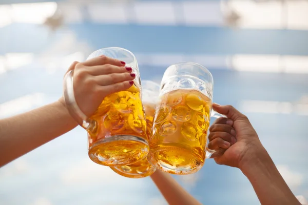 Raised beer mug toasting at Oktoberfest — Stock Photo, Image