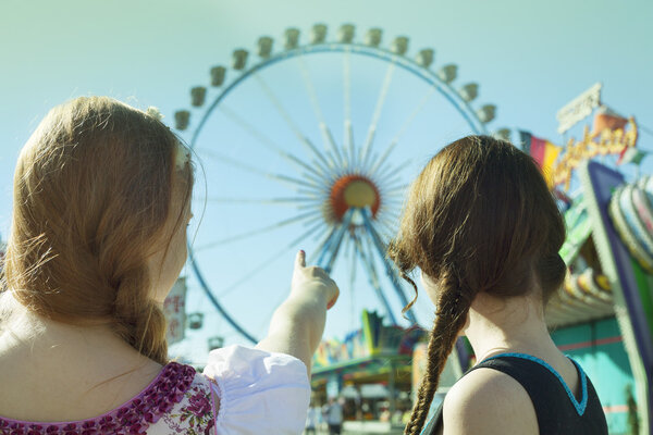 German girls going to big ferris wheel at Oktoberfest
