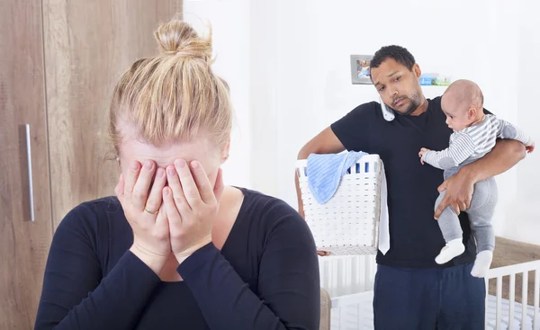 Husband overwhelmed by taking care of everything alone, because his wife is suffering from postpartum depression — Stock Photo, Image