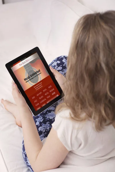 Young woman with music website open on tablet device