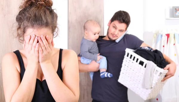 Husband overwhelmed by taking care of everything alone, because his wife is suffering from postpartum depression — Stock Photo, Image