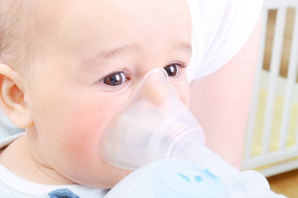 Baby boy at the hospital gets inhaler treatment for cough