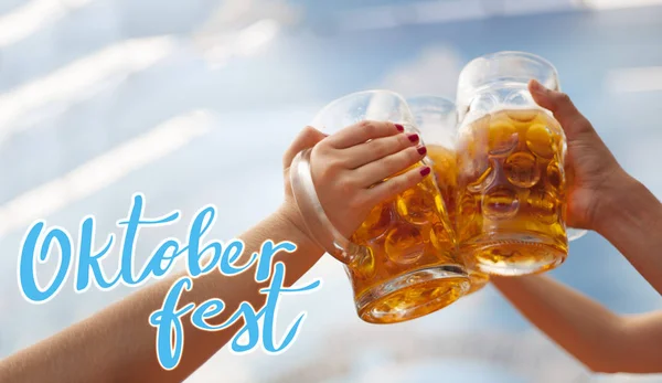 Raised beer mug toasting at Oktoberfest — Stock Photo, Image