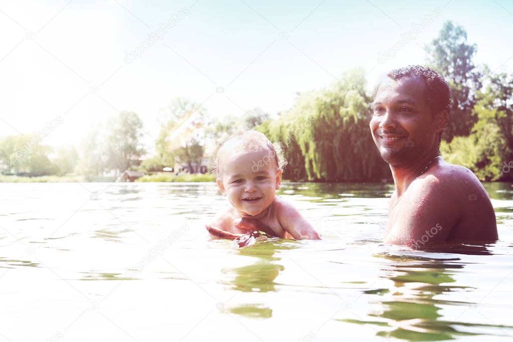 Happy toddler learning to swim