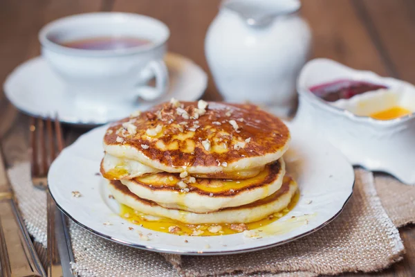 Pancakes with walnuts and syrup for breakfast — Stock Photo, Image