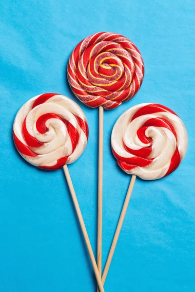Lollipops on a stick on a blue background