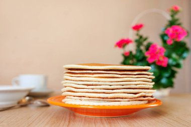 Real food. Pancakes on the table with home flower. Authentic breakfast