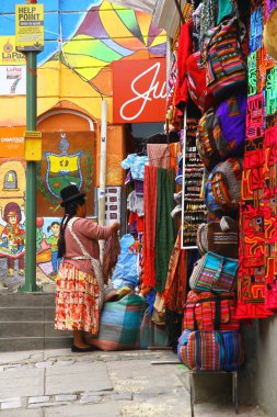 LA PAZ, BOLIVIA - 18 Mart 2019. La Paz 'daki renkli hediyelik eşya dükkanlarıyla dolu bir cadde manzarası. Şehrin en önemli turistik yerlerinden biridir..