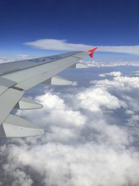 Pencereden bulutlu manzara ve uçak kanadı görüntüsü