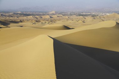 Sand dunes around Huacachina oasis in Peru. clipart