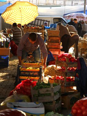 View on the bazaar, a row with vegetables, vendors unload goods
