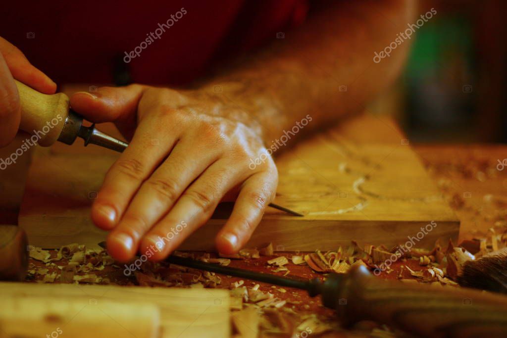 View on hands of the artisan man, woodcarver