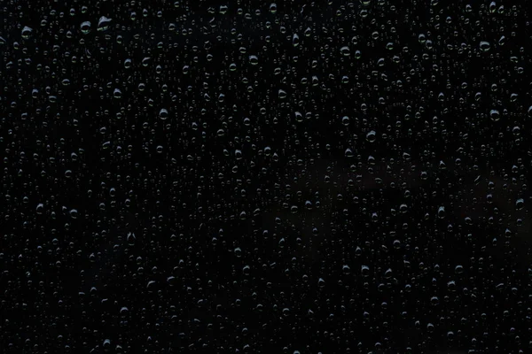 Water raindrops on a shiny dark black surface — 스톡 사진