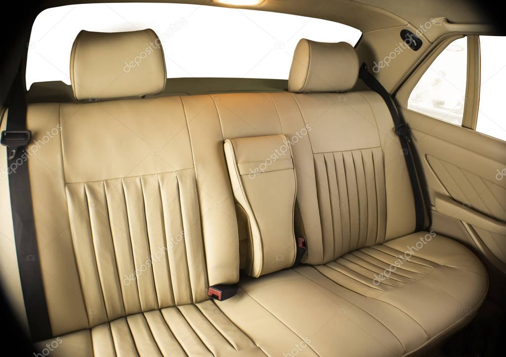 back seats of the car tugged with beige, natural, perforated leather