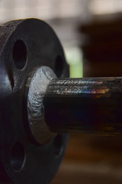 Closeup welding connection between pipe and flange. Welding by Tungsten Inert Gas Welding process (TIG).