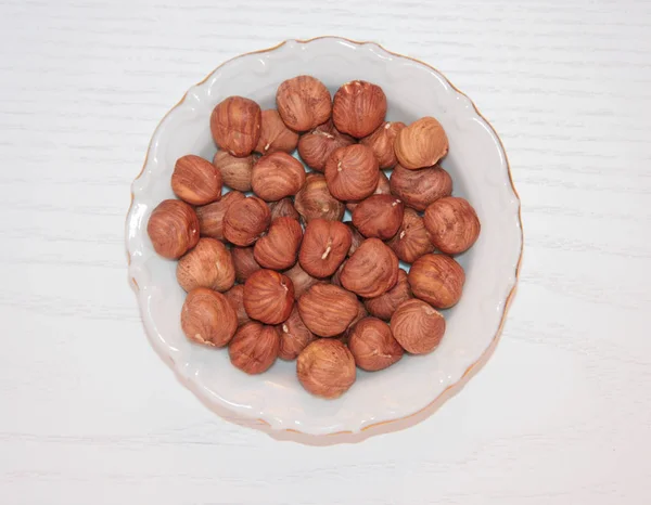 Hazelnuts White Plate Light Wooden Surface Hazelnut Shell Small Plate — 스톡 사진