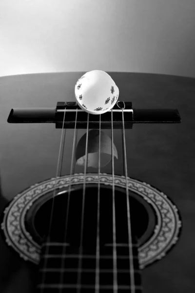 view over the guitar neck to the guitar bridge with the six strings