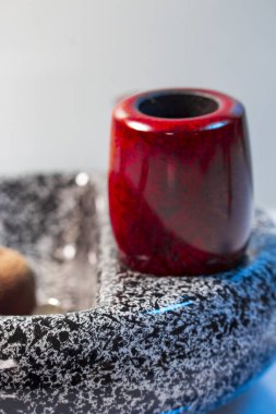 Macro picture ashtray with red pipe