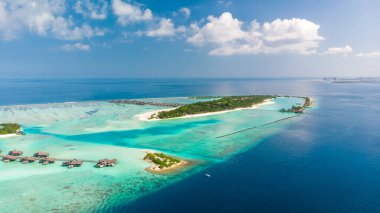 Resorts of the Maldives. Holiday in paradise, Maldives. Aerial view maldives islands with water villas. clipart