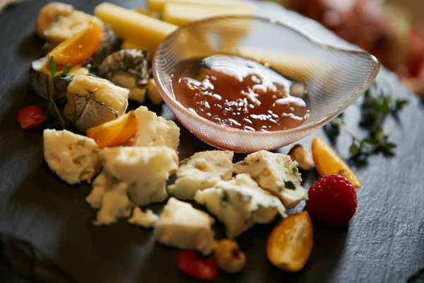 plate of cheese and fruits