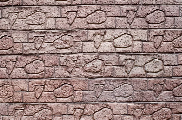 Roter dekorativer Reliefputz, der Steine an der Wand imitiert — Stockfoto