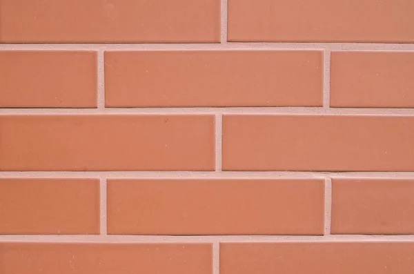 Red ceramic slabs imitating bricks on wall — Stock Photo, Image
