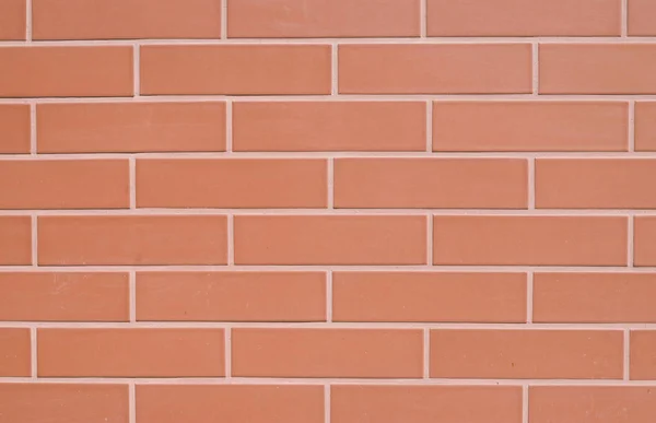 Red ceramic slabs imitating bricks on wall — Stock Photo, Image
