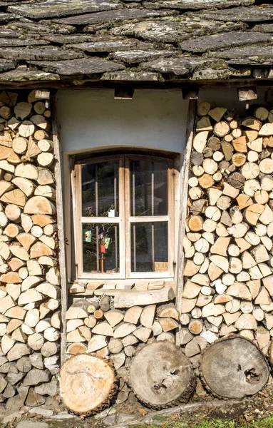 Venster van Berghuis met stenen dak en brandhout, Bulgarije — Stockfoto