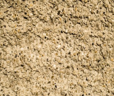 Sarı dekoratif yardım sıvası duvarda. 