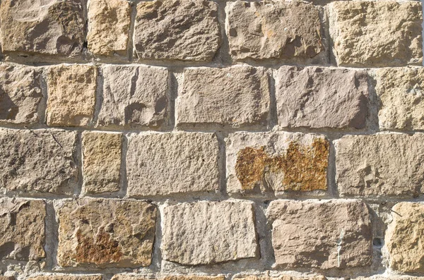 Old stone wall closeup  in sun — Stock Photo, Image