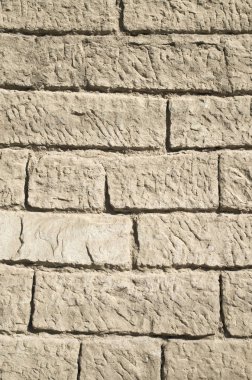 Güneşli bir günde closeup eski Ekru taş duvar