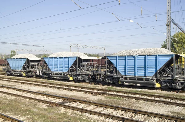 Three freight wagons with gravel on the siding — Stock Photo, Image