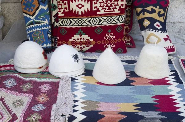 Албанские сувениры - шляпы, подушки и ковры — стоковое фото