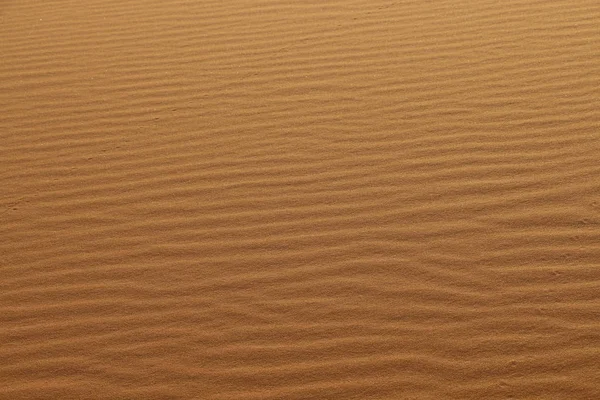 砂のテクスチャ 砂漠の砂丘の背景 砂丘の美しい構造 砂漠の風が吹く砂 Close — ストック写真