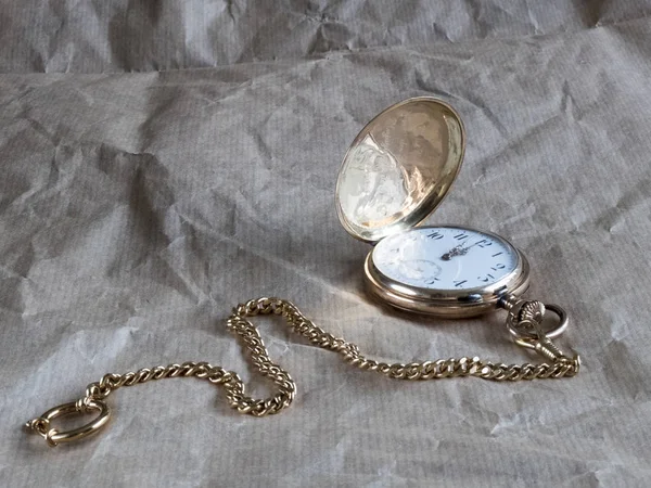 old pocket gold watch on the table