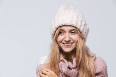Studio portrait of attractive joyfully smiling girl in pink sweater and white hat, dressed casually/ being happy, good-looking beautiful woman, positive emotions, perfect skin, face expressions.