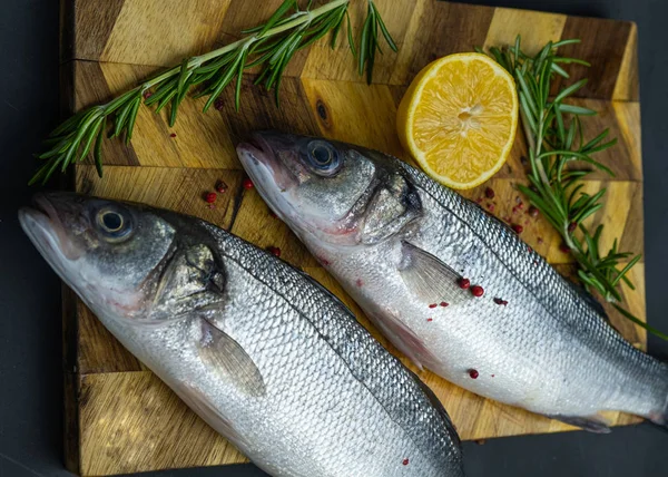 Lubina Fresca Con Limón Romero Sobre Una Tabla Madera — Foto de Stock